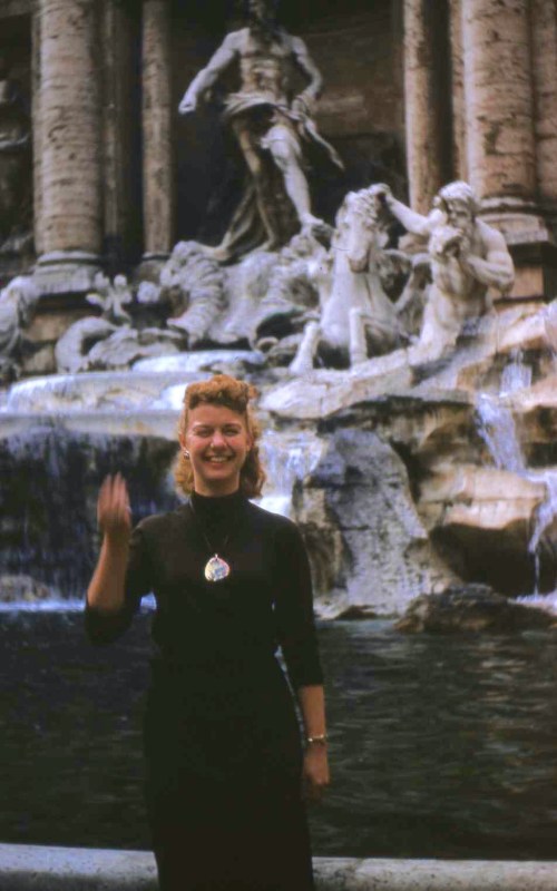 Rusty throws a coin and a wish into Trevi Fountain.